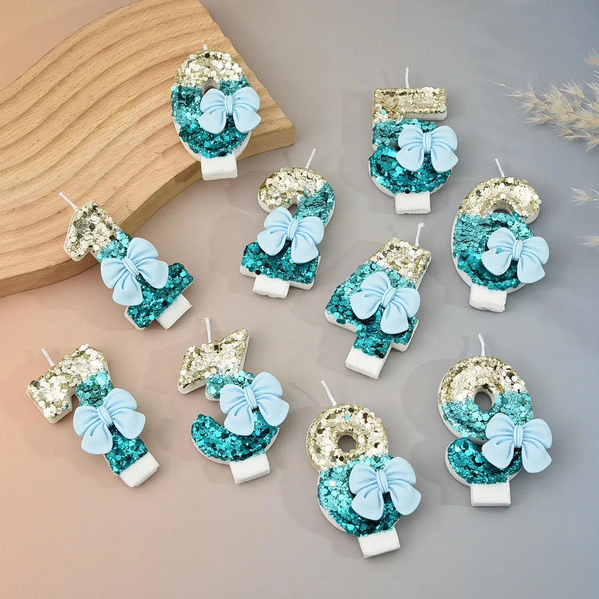 Gold and blue contrasted sequined pale blue bow-shaped number candles, party gifts, birthday and anniversary candles