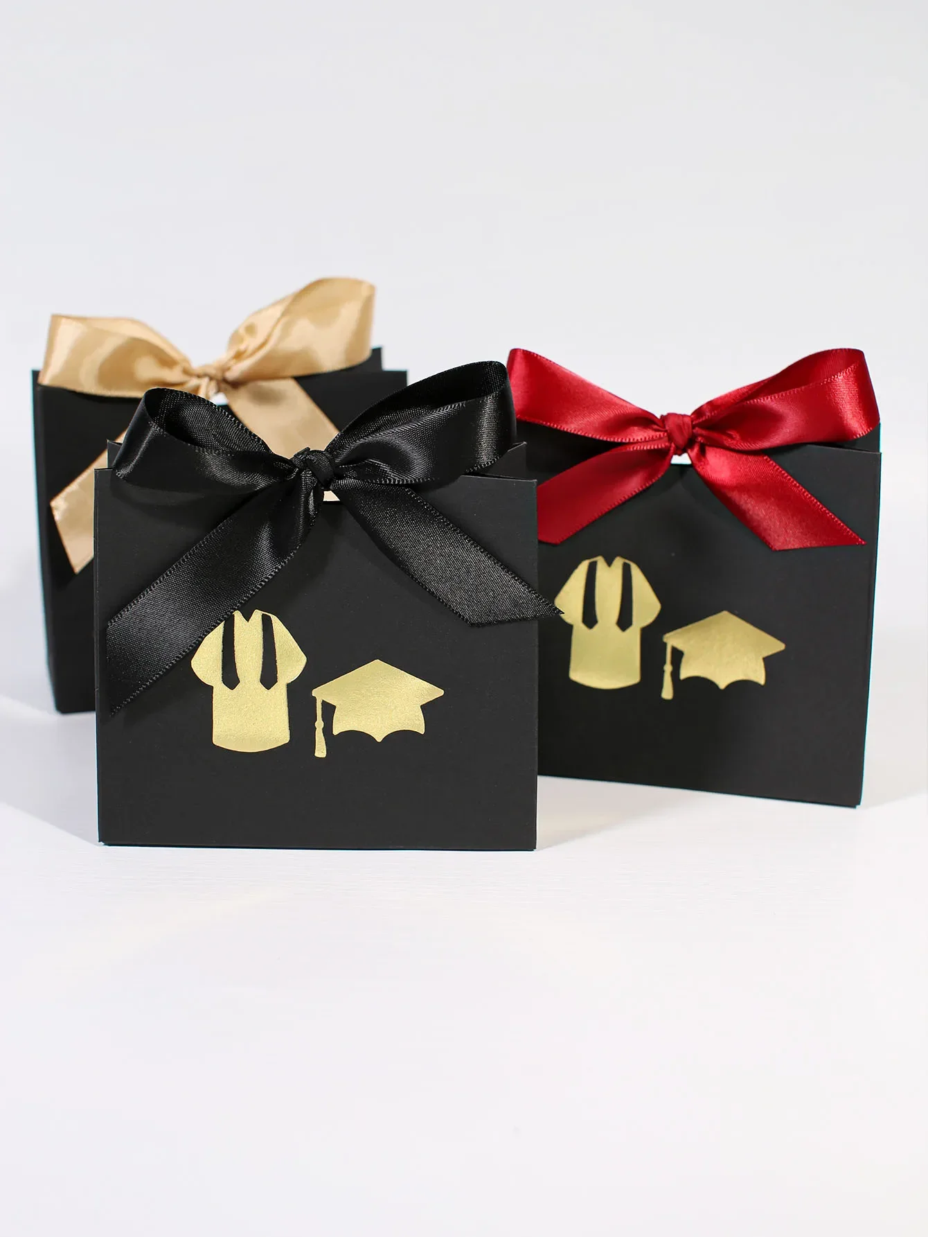 Schwarzer Hintergrund, goldene Dekoration, Abschluss-Gedenk-Geschenktüte, glücklicher Abschluss, Abschlussfeier-Dekoration, Doktorhut