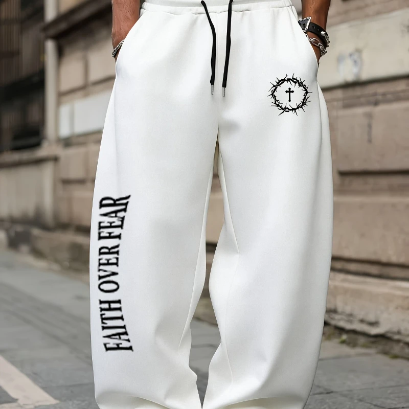 Men's athletic pants featuring the unique "FAITH OVER FEAR" slogan and a graphic print combining a crown of thorns with a cross. view 2