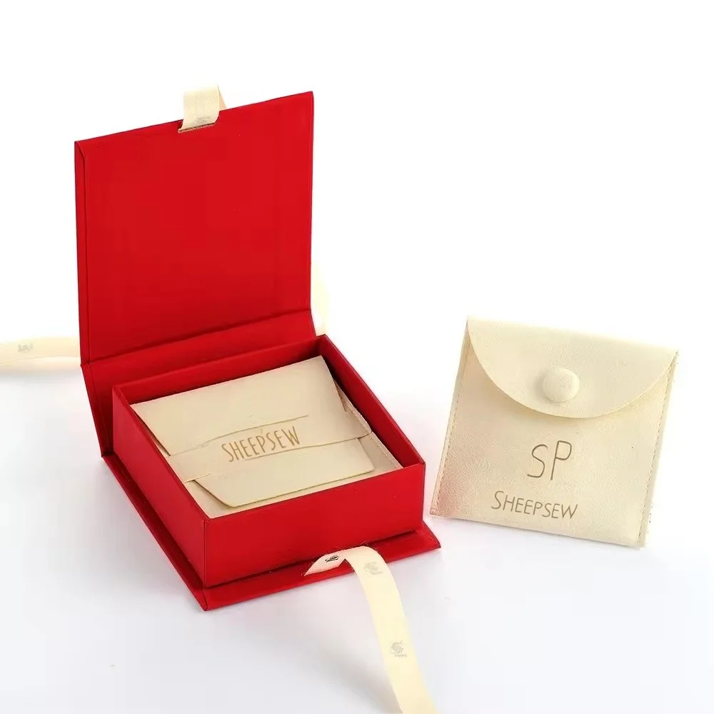 

New Design Beige Microfiber Pouch Emboss LOGO Foldable Cardboard Foam Insert Gold Ribbon Jewelry Packaging Display