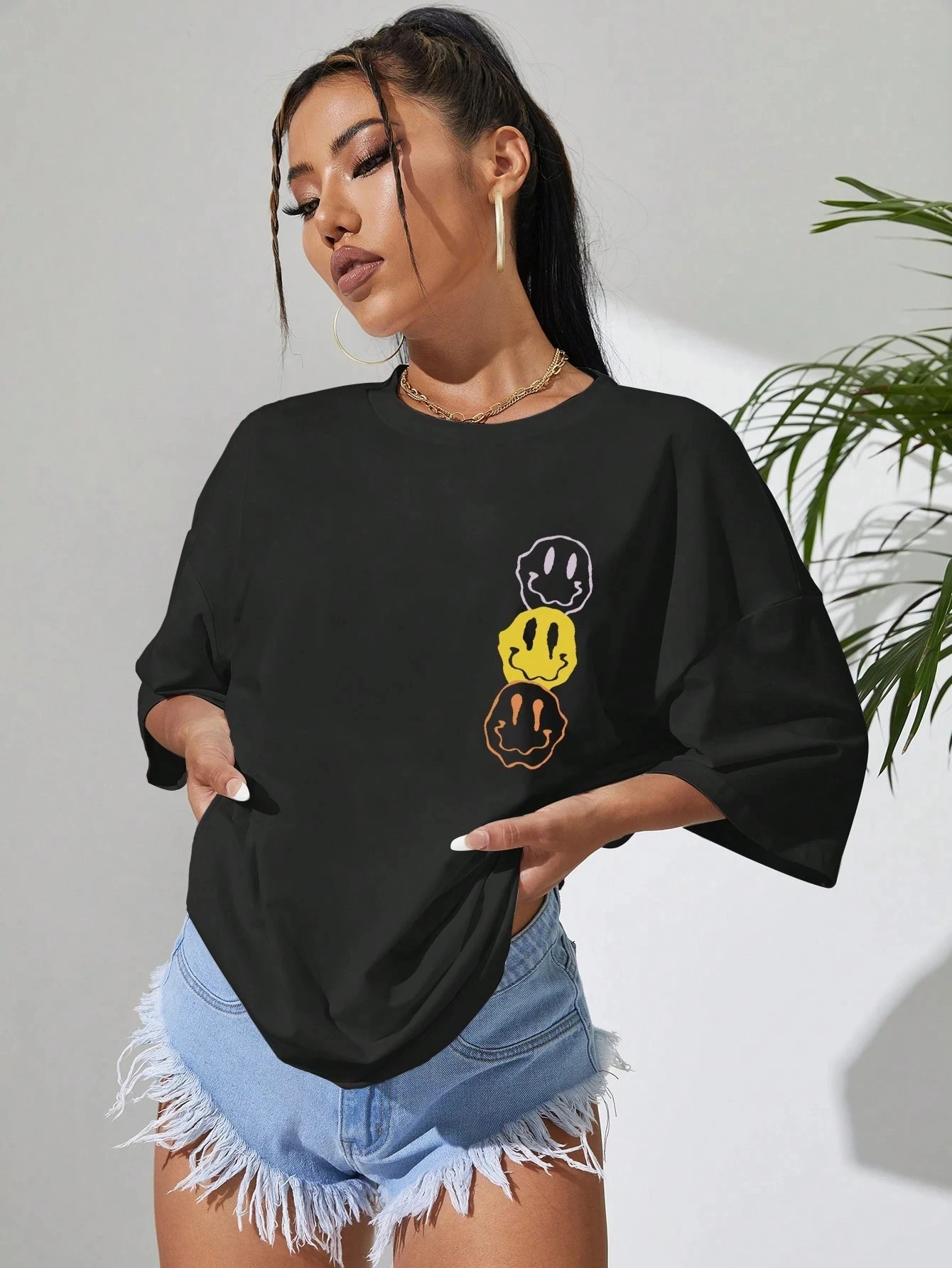 Camiseta negra de gran tamaño de talla grande con estampado de cara sonriente apilada de moda para looks casuales de moda