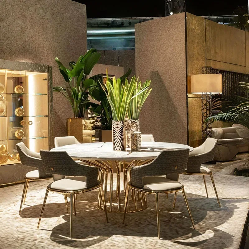 Mesa de comedor italiana y silla, combinación ligera de lujo, mesa redonda de mármol de alta gama, comedor moderno de acero inoxidable de alta gama para el hogar