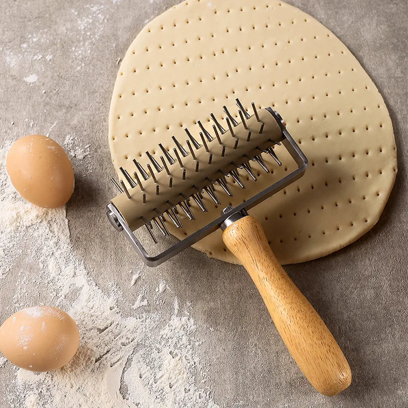 Stainless steel pizza perforator with ergonomic roller needle mechanism and non-slip rubber-wood composite handle for precise do