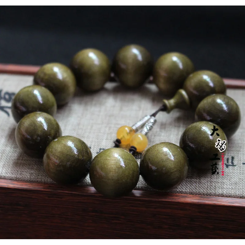 

Golden with colored Buddhist beads and amber, smooth grain nanmu dark wood bracelet