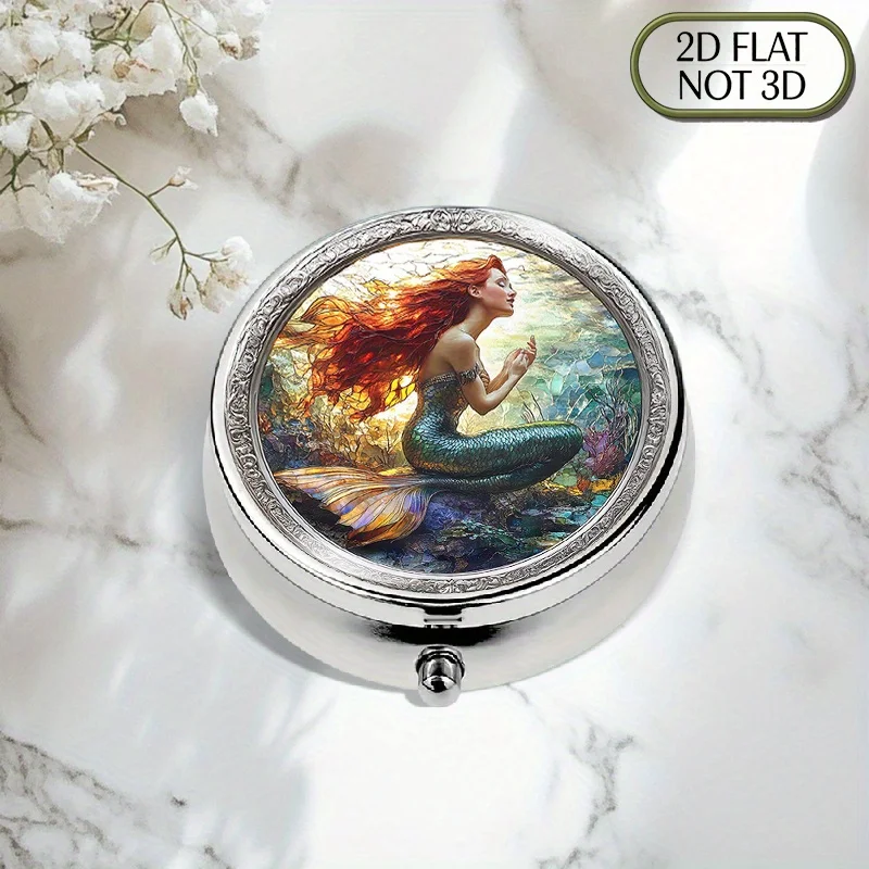 A flat, portable, round metal pillbox featuring a beautiful mermaid scene in stained glass, elegantly stores medication and supplements, ideal for organizing vitamins, small accessories, or coins, perfect for travel, sports, or as a thoughtful gift