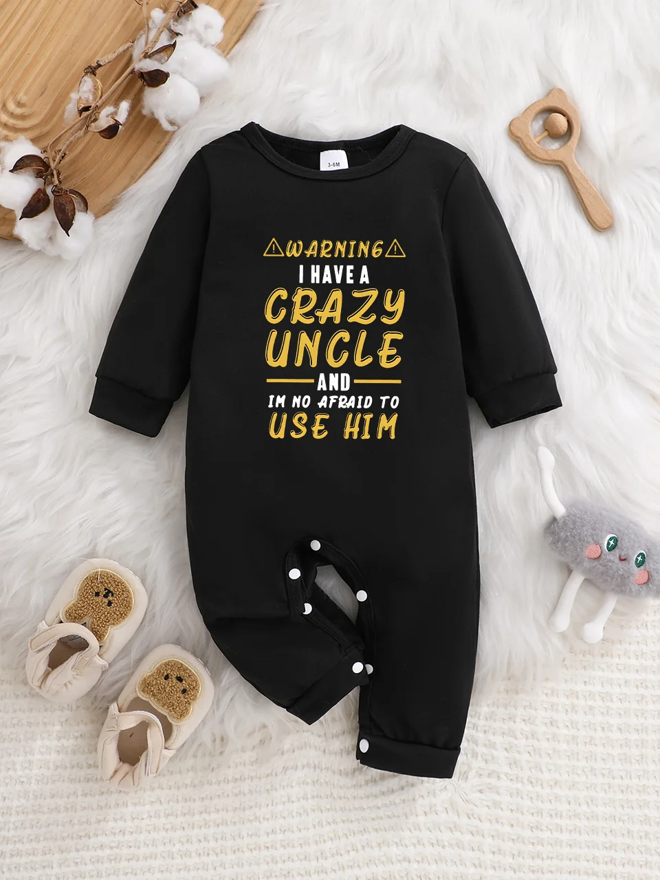 A baby long-sleeved onesie with interesting letter prints. It features a buttoned design for easy putting on and taking off, and