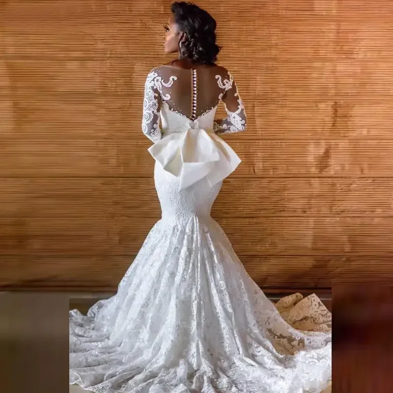 Abiti da sposa africani personalizzati in pizzo a sirena Vestido De Noiva Abiti da sposa da donna Manica lunga Fiocco con bottoni posteriori Sposa trasparente