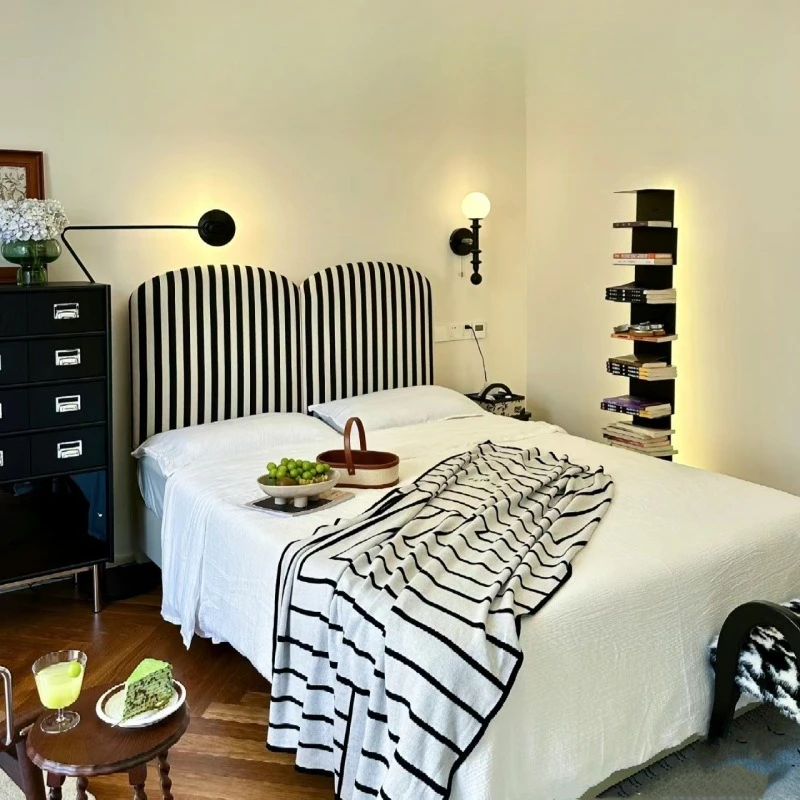 

A zebra-patterned black and white vertical striped fabric bed, and a master bedroom wedding bed.