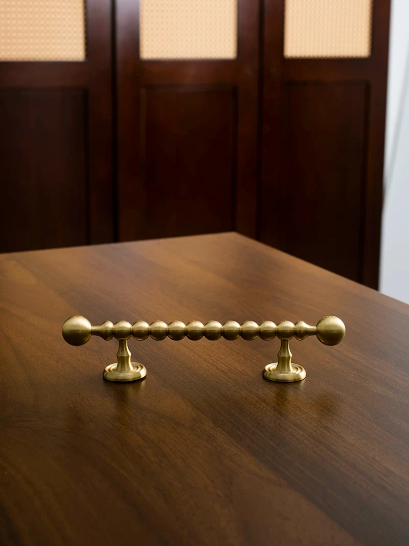Beaded cabinet handle in brushed brass shown in the supplier product illustration 16