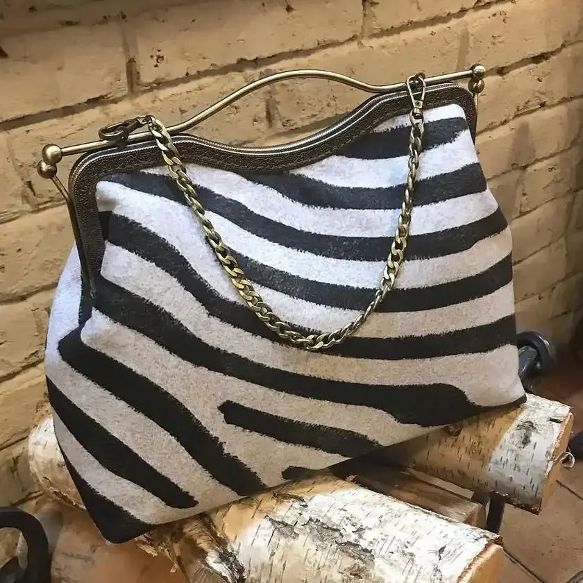 

LOST IN VINTAGE Tapestry-style zebra fabric purse with a chain link handle and elaborate metal frame studded bag