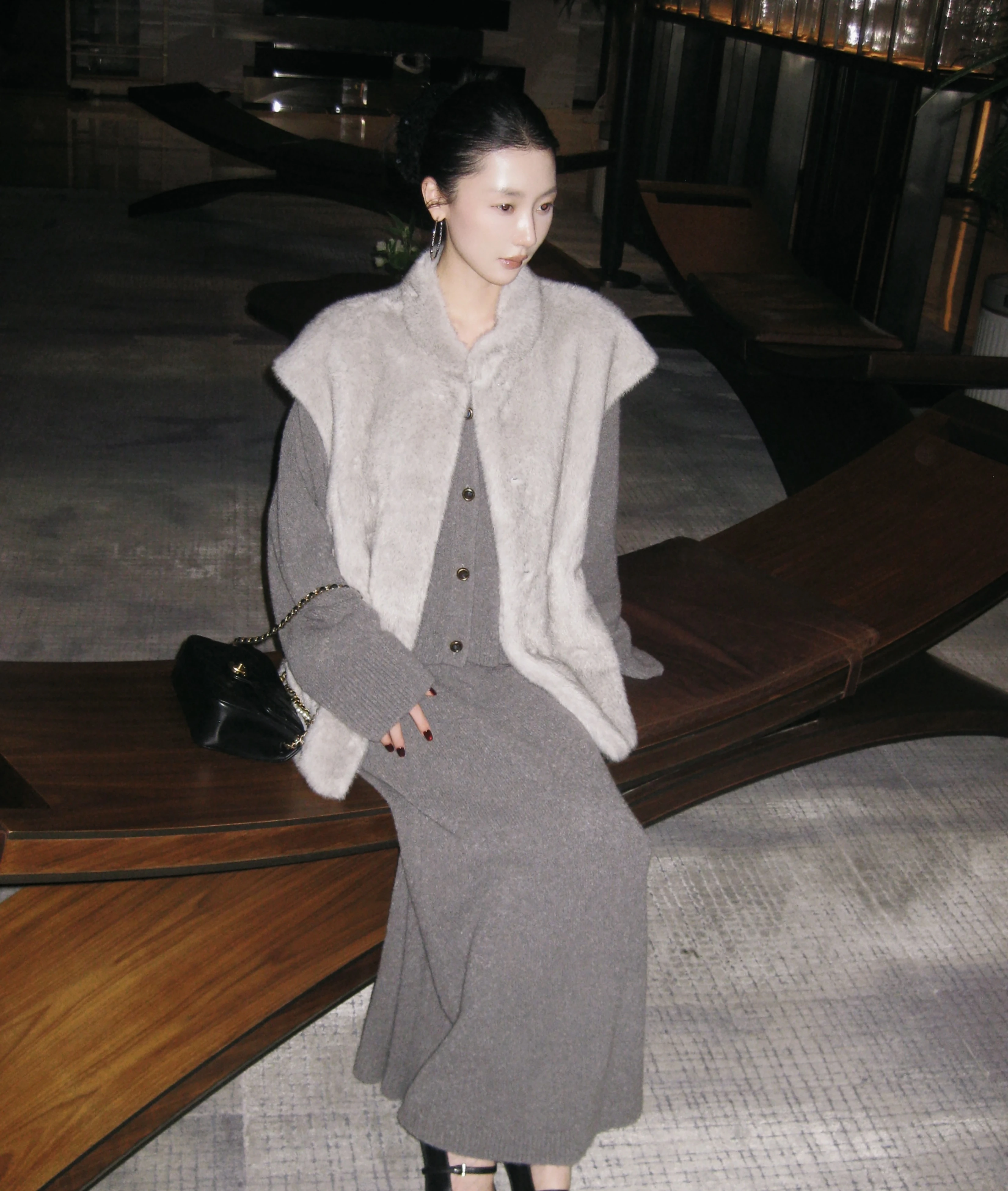 A high-end, lustrous fur coat for women in winter, with a cinched waist and elegant, eco-friendly fur vest