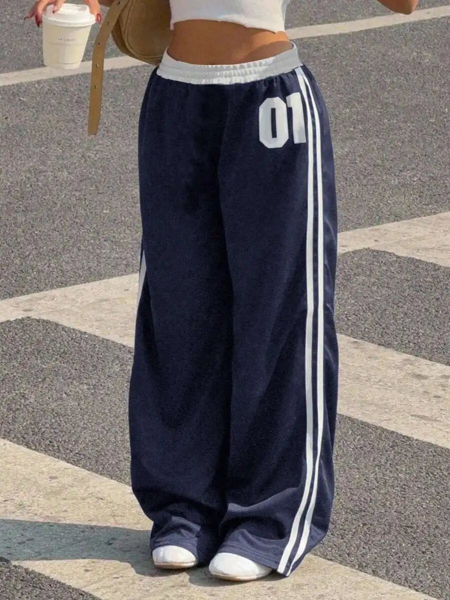 

Темно-синие спортивные брюки свободного кроя с белыми полосками и цифровым принтом