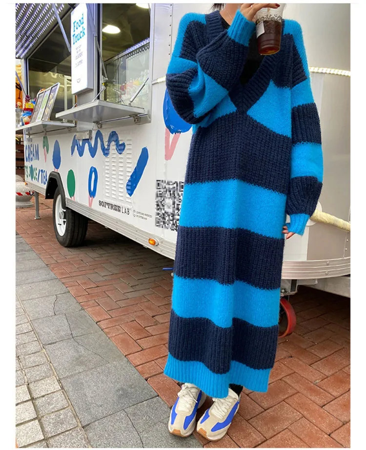 A long skirt in a loose striped sweater dress falls below the knee