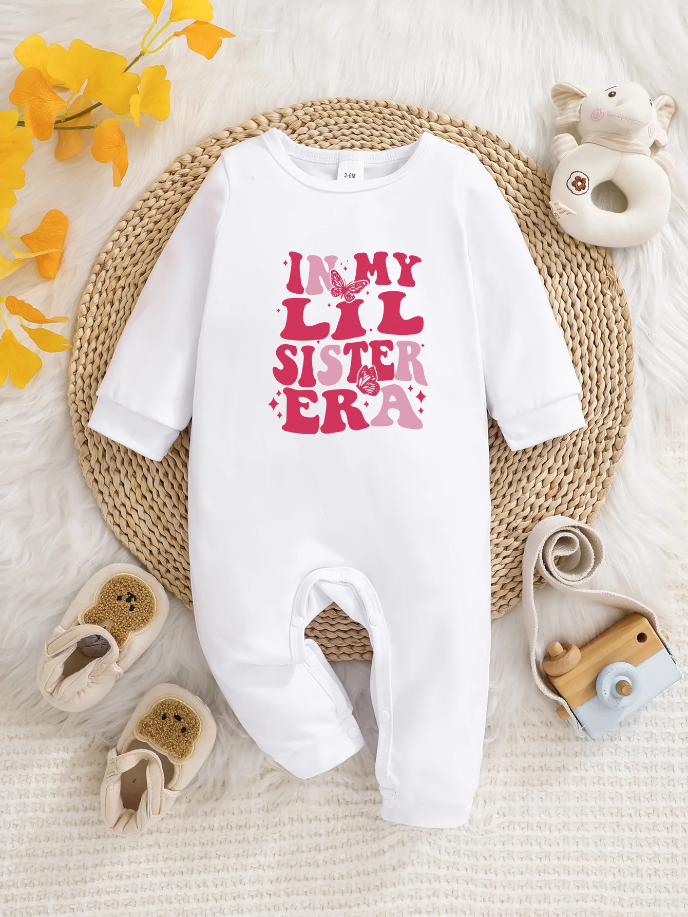 Baby long-sleeved bodysuit with fun letter prints, button design, easy care, suitable for new parents.
