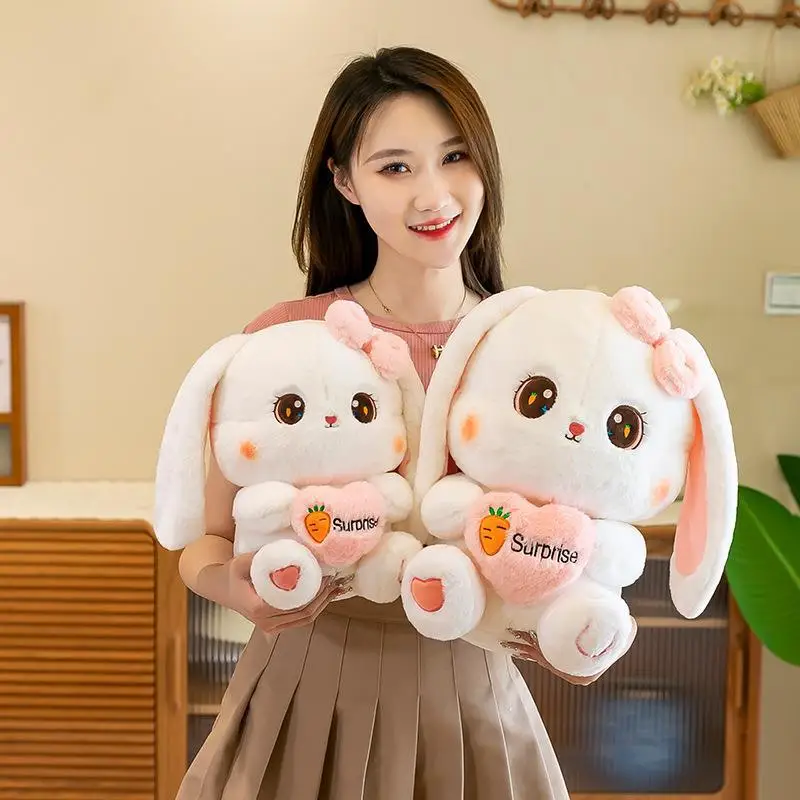 Simpatico coniglietto di peluche Kawaii, coniglietto di peluche che tiene una bambola con orecchie a cuore, regalo di compleanno per fabbrica di coppie di ragazzi e ragazze