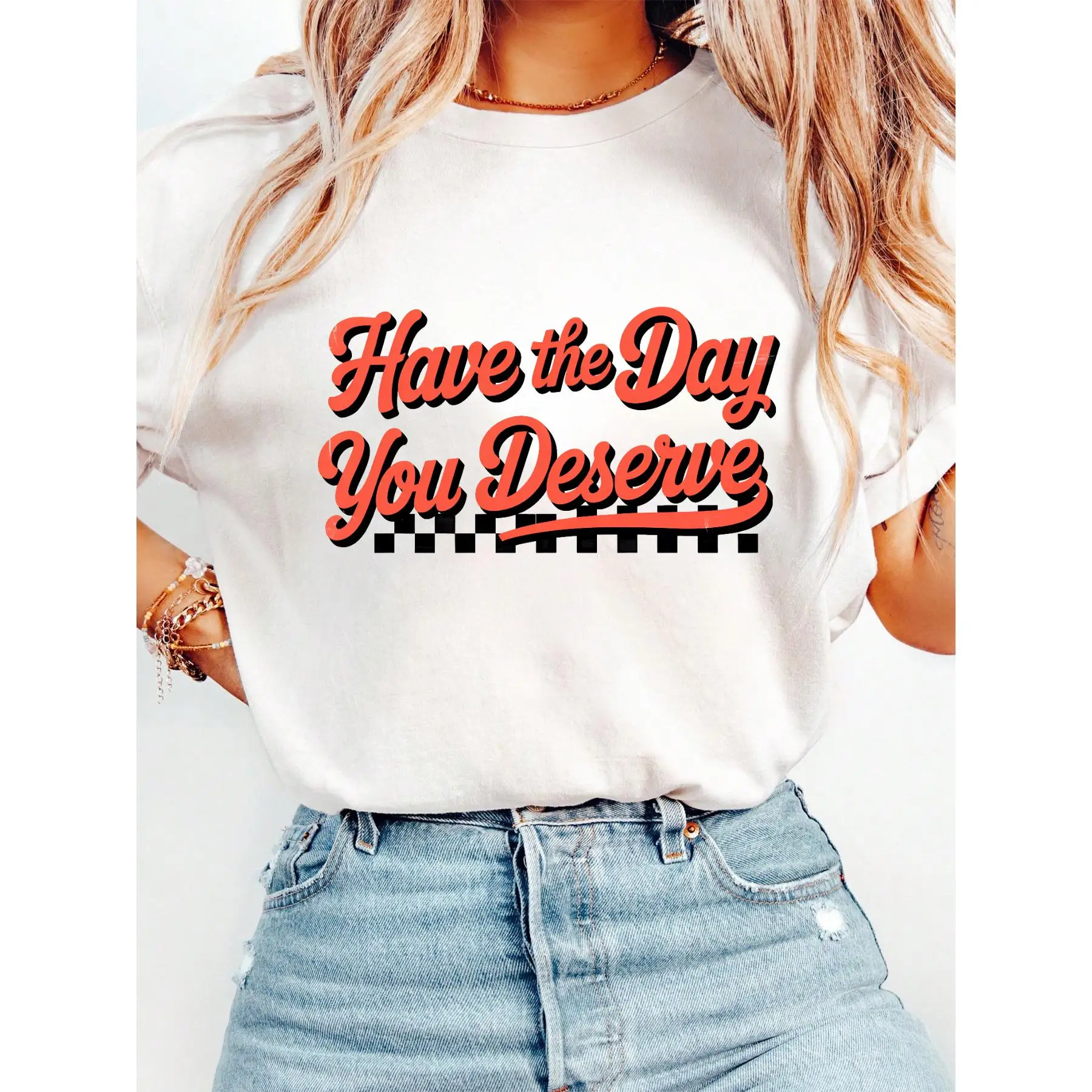 

T - Shirt With “Have The Day You Deserve” Slogan And Checkered Design, Perfect For Daily Motivation.