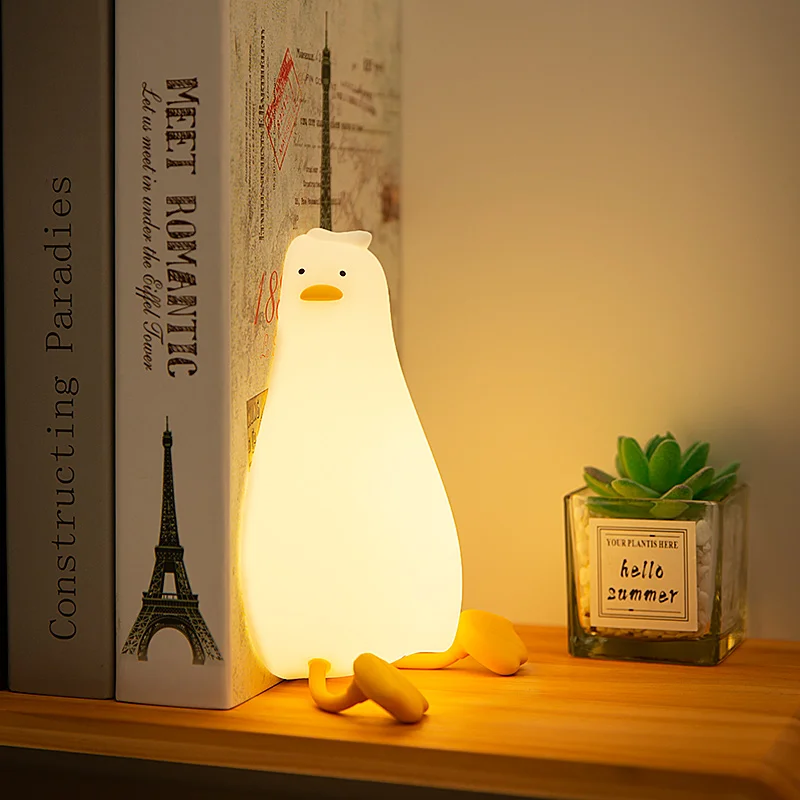 Lying Flat Duck Night Light Silicone Squishy Rechargeable Tap Control 3 Brightness 30 Min Timer Phone Holder for Bedside view 4