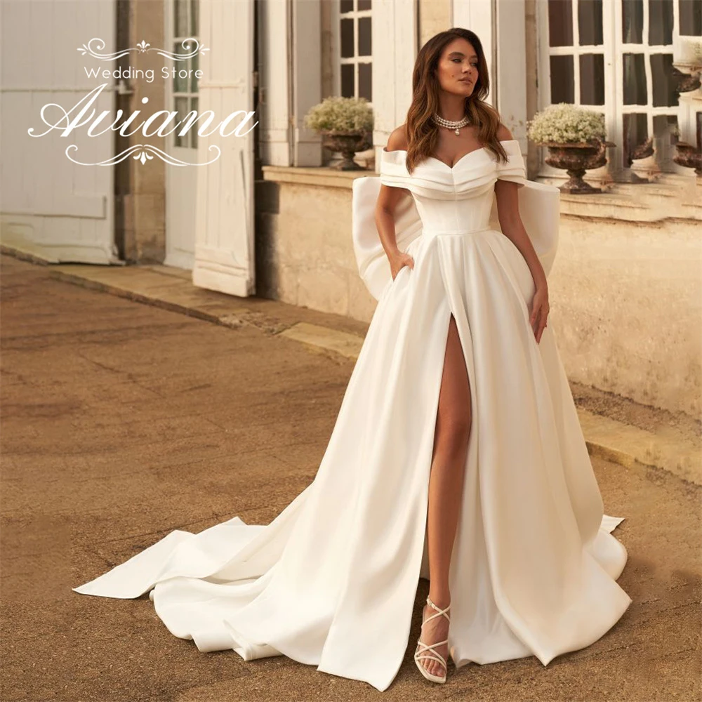 فستان زفاف Aviana مخصص على شكل قلب على شكل حرف a مع فيونكة خلفية وفتحة عالية سويب تراين بطول الأرض وكشكشة على طراز الأميرة الأنيق