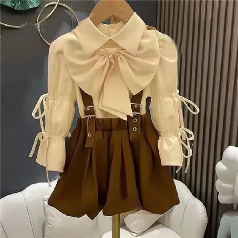 

Girls' Spring and Autumn Set New Fashion Korean Children's Sweet Cool Drawstring Shirt Bow Strap Skirt 2PCS Kids Outfit Set