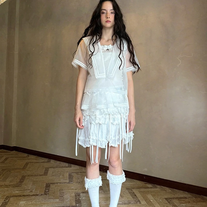 2025 الربيع الصيف الخريف الأبيض القوس لطيف المرأة مطوي تنورة قصيرة التصميم الأصلي الحلو شاش شفاف ضرطة الستار السيدات