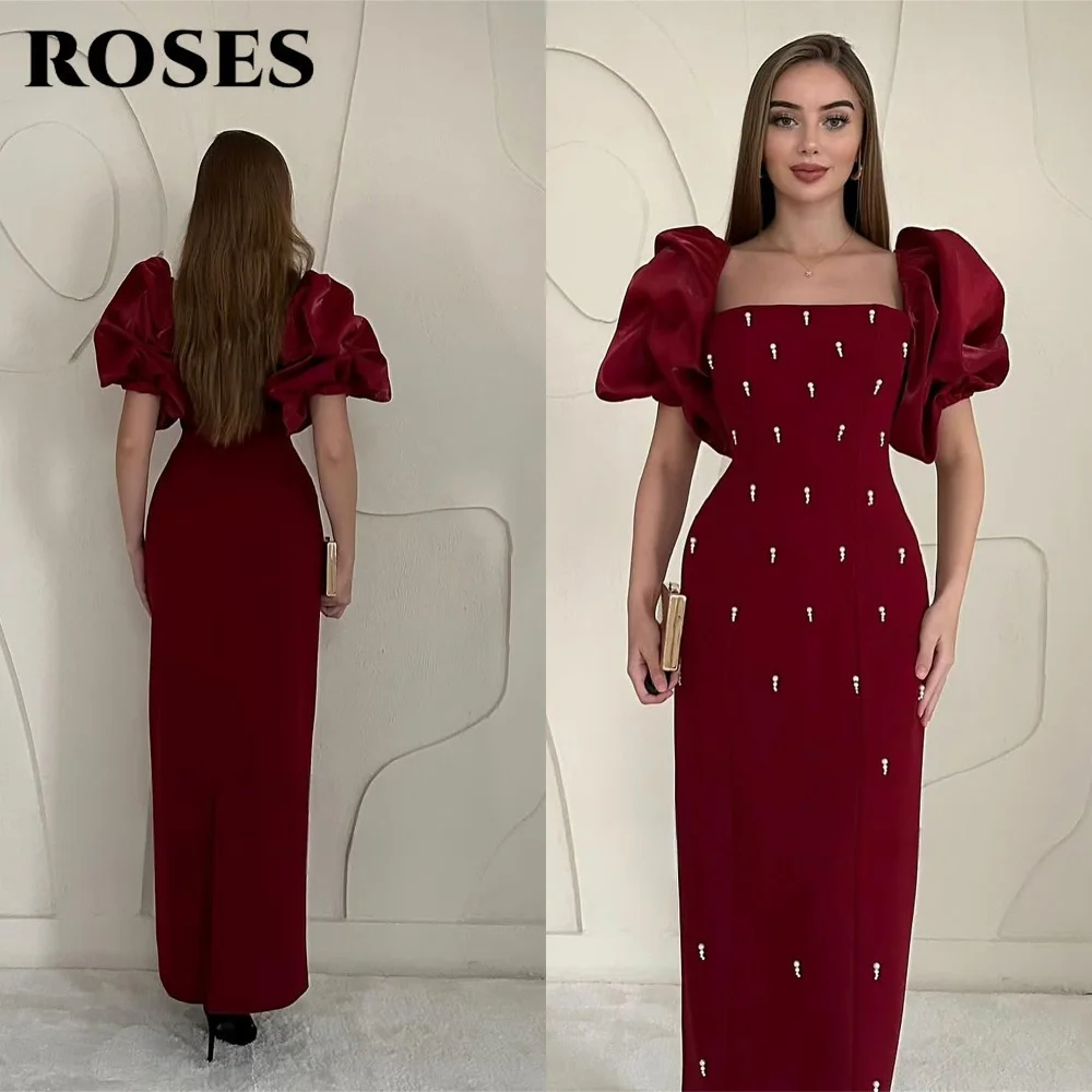 فساتين حفلة موسيقية أنيقة باللون العنابي من ROSES فساتين سهرة بخط عنق مربع وأكمام منتفخة منظمة وتفاصيل متألقة حسب الطلب