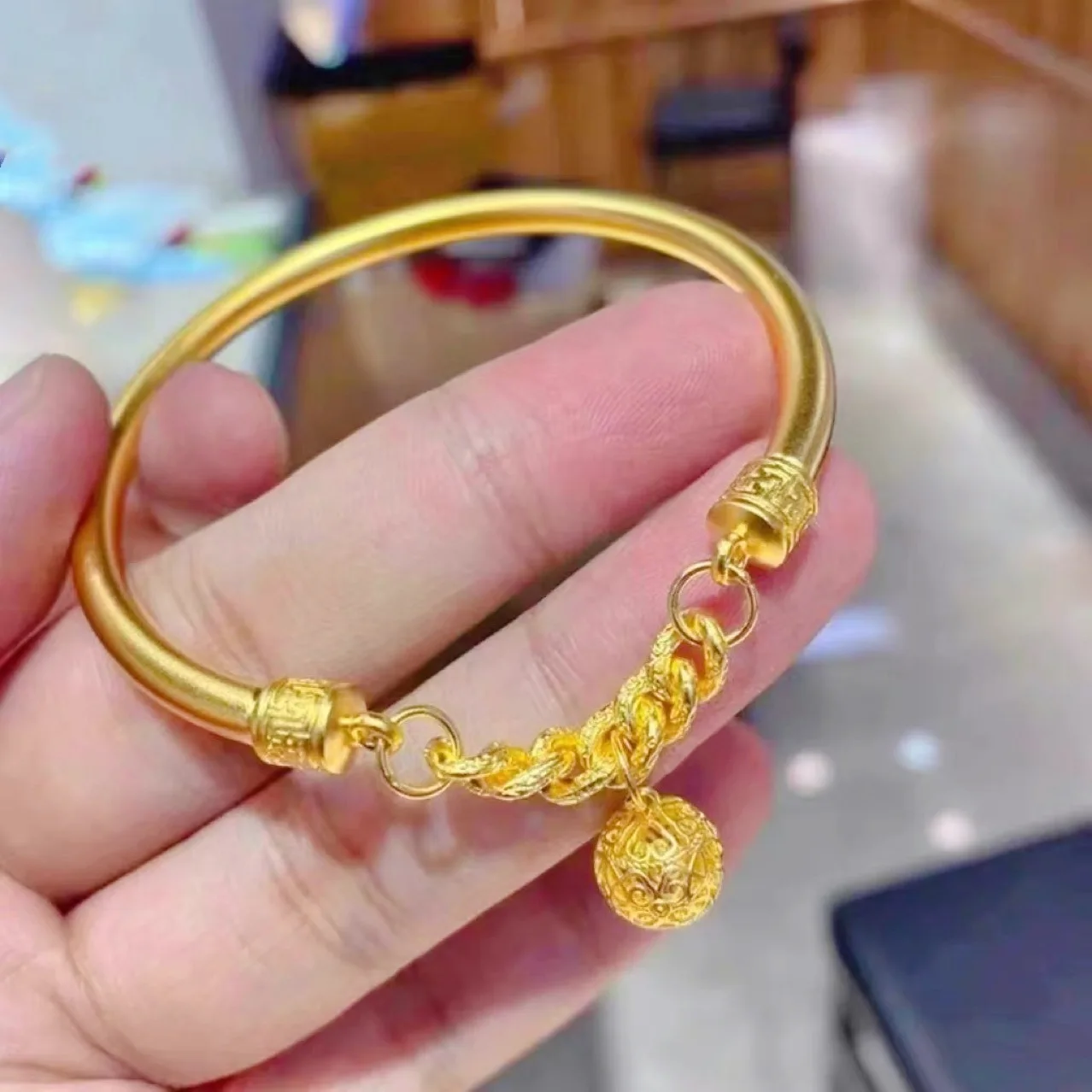 

Bell Bangle for Women, 24K Gold, AU999 | Matte gold with "Joy" engraving & wave motifs, subtle professional melody.