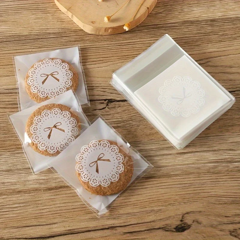 100 Uds. Bolsas de poliipropileno transparente autoselladas con diseño de lazo blanco galletas pastel Chocolate dulces bocadillos embalaje