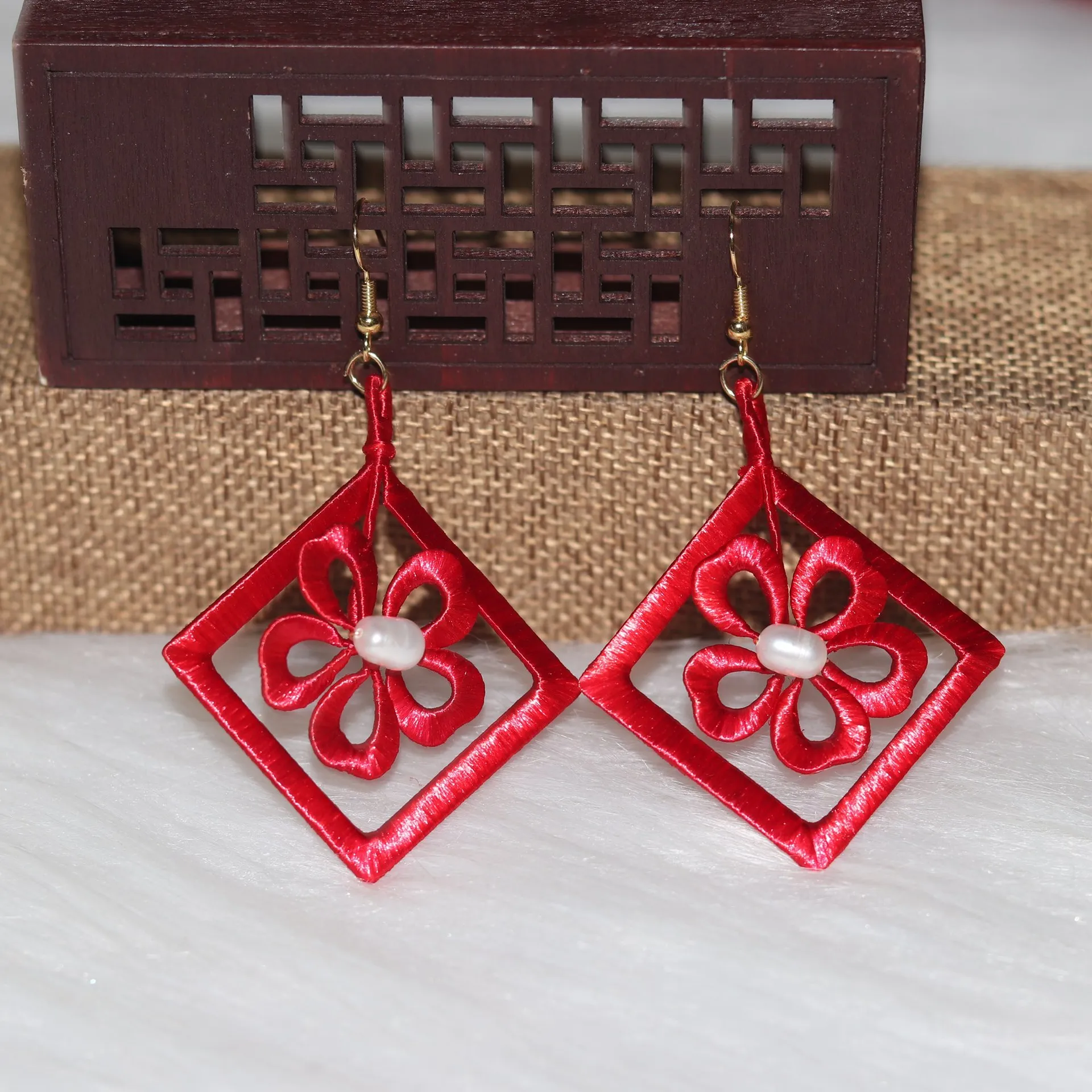 

Handcrafted Red Window Flower Entwined Earrings, Classical Red Plum Blossom Pearl Ear Hooks, And Elegant Red Jewelry