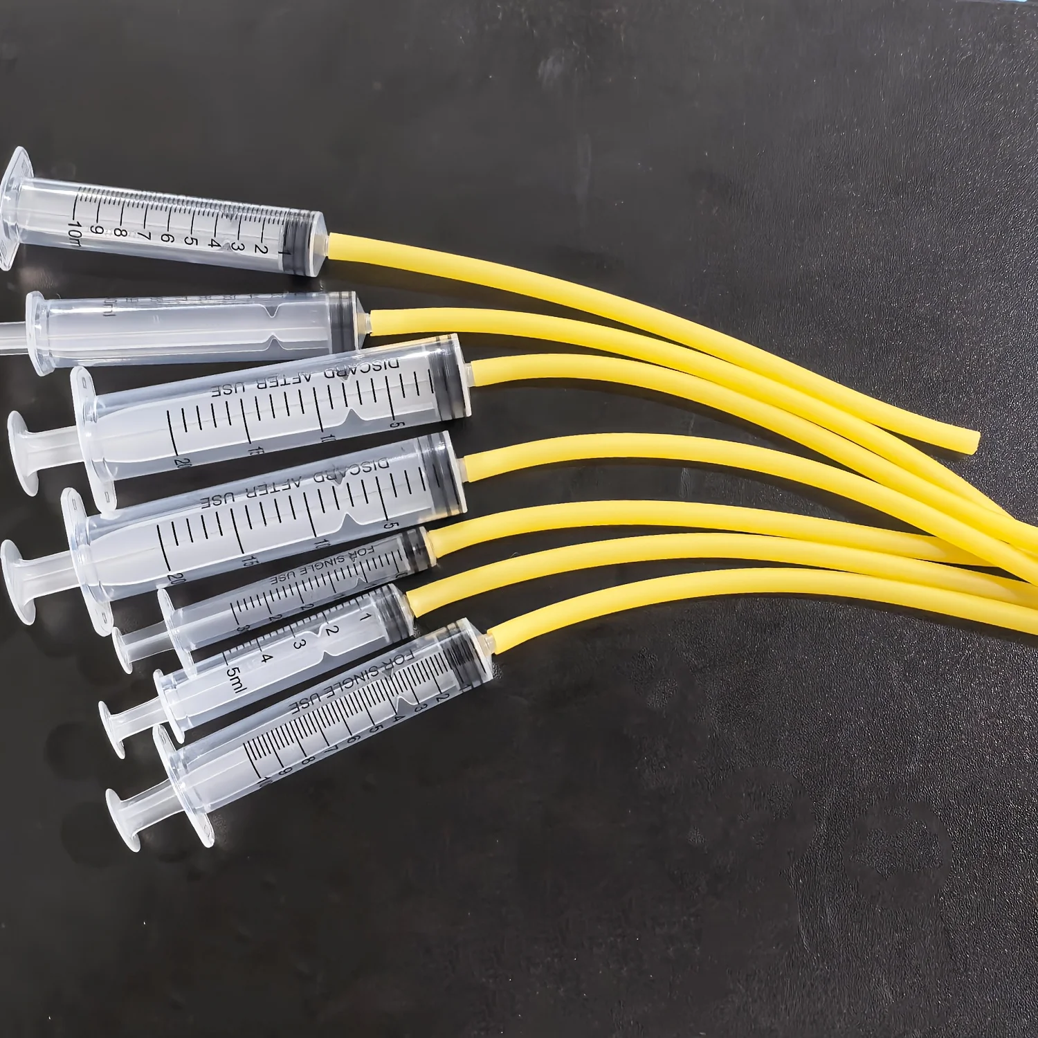 

3 ml/5 ml/10 ml/20 ml syringes, with 15 cm yellow rubber tubes attached, suitable for liquid transfer, animal feeding, etc.