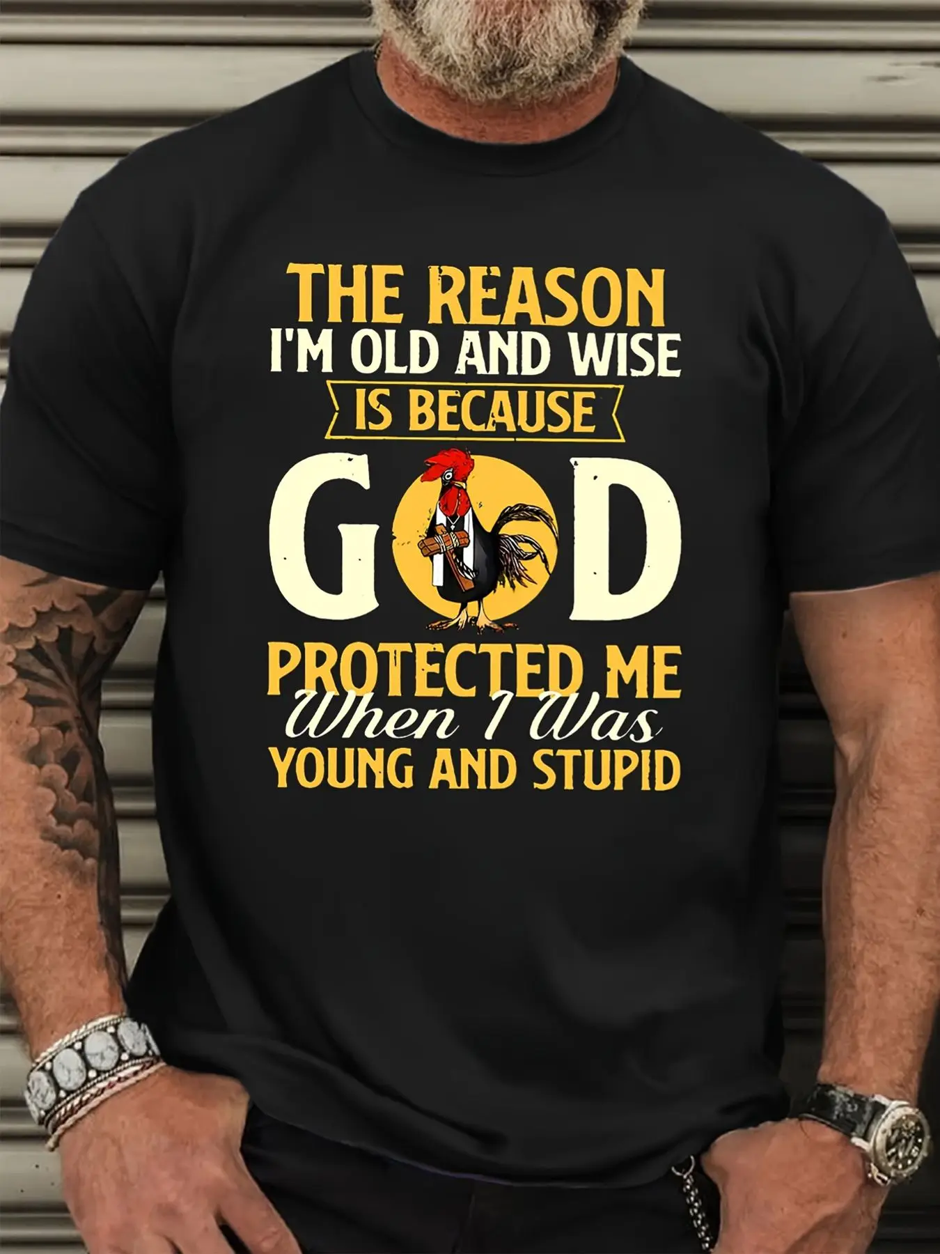 Plus-Size Men's Clothing Protective Wisdom Men's T-Shirt - Bold Graphic Design Featuring Rooster and Inspirational ASON I AND WISE IS BECAUSE GOD PROTECTED ME WHEN I WAS YOUNG AND STUPID' - Great Gift for Encouraging Friends and Family on Casual Occasions