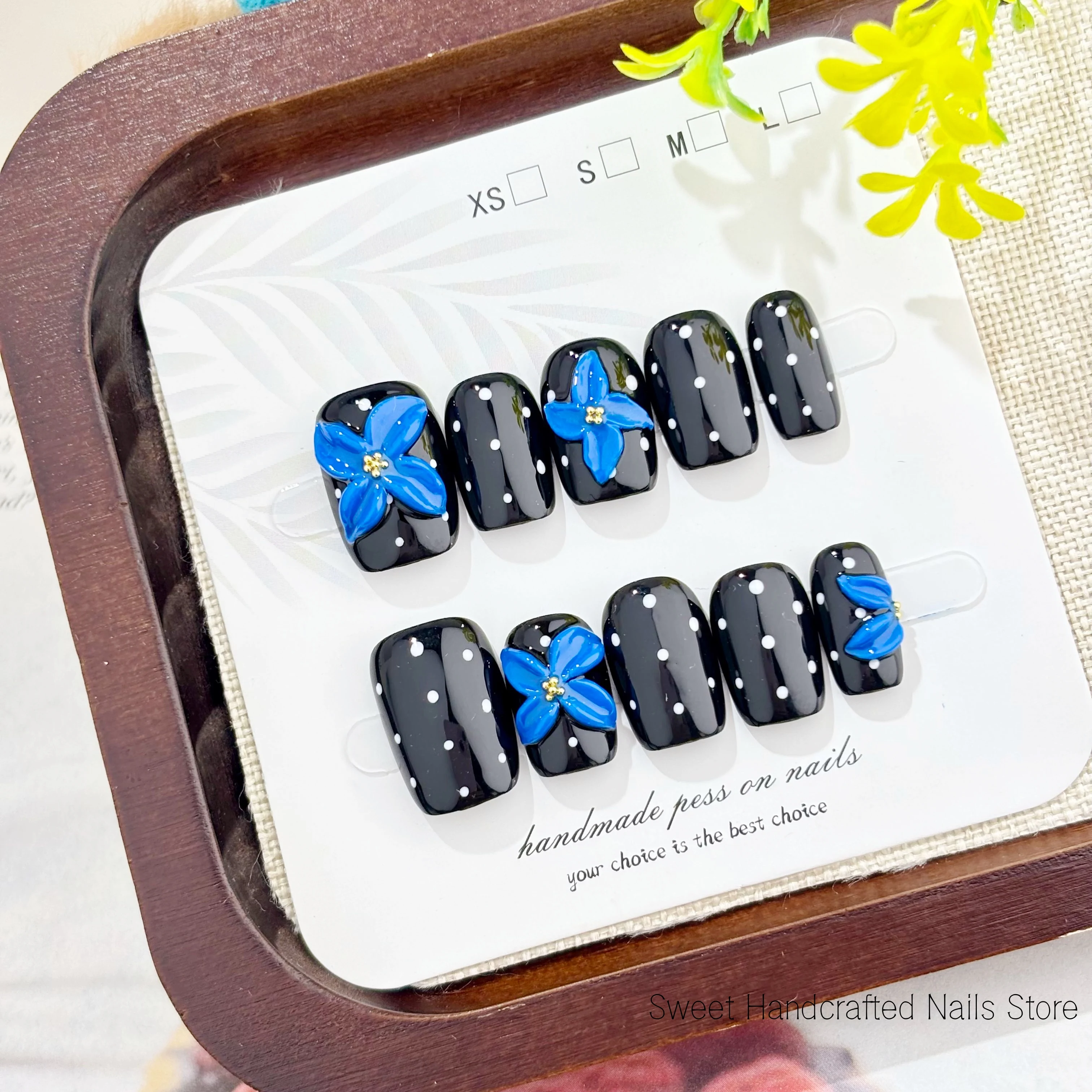 High-end handmade short square press-on nails, deep black with white polka dots, featuring 3D blue carvings and gold beads, reusable and perfect for everyday wear or Halloween nail gift, comes with a nail tool kit