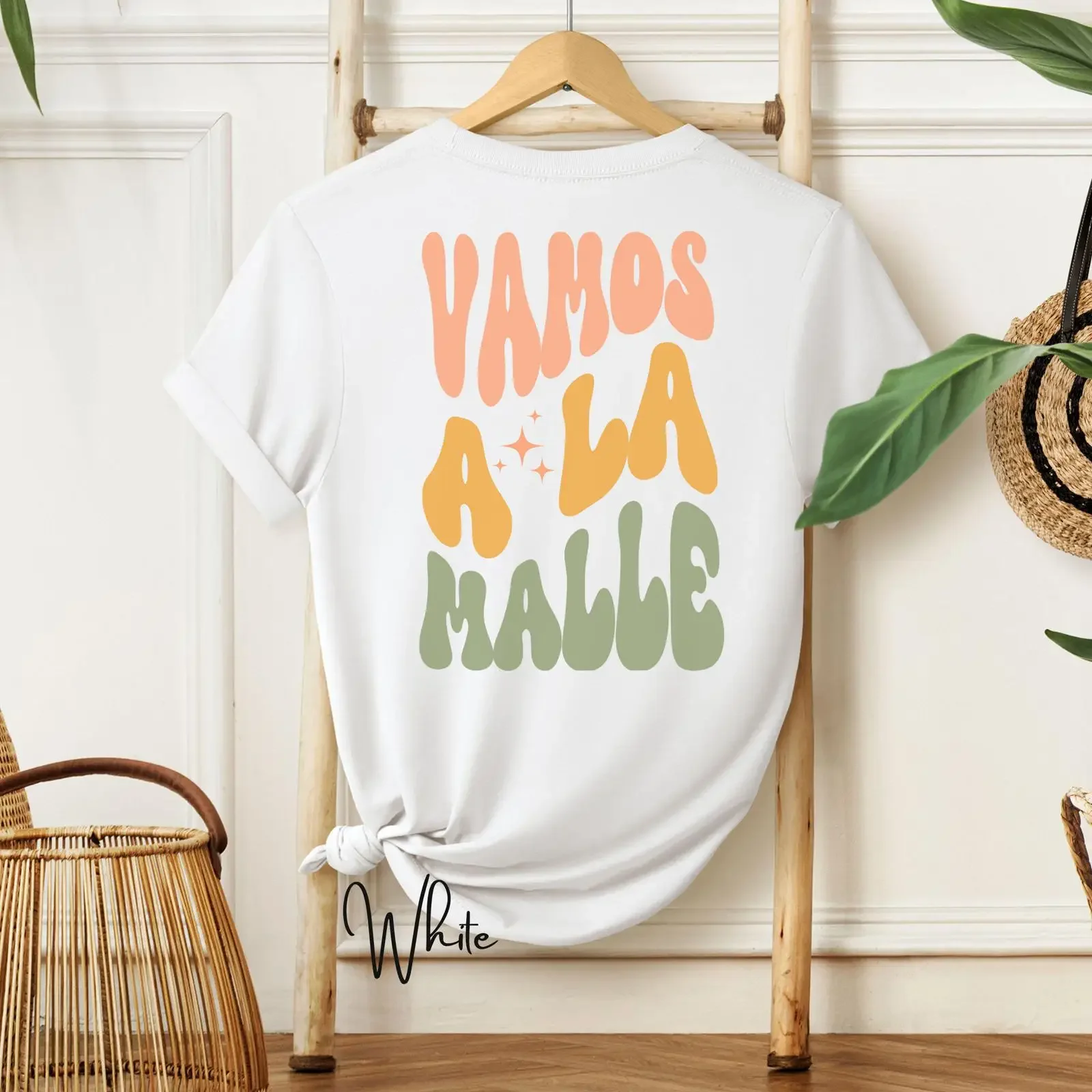 May include White t shirt with the text Vamos a la Malle in retro colorful font vintage Washed Top For Everyday Wear Slightly