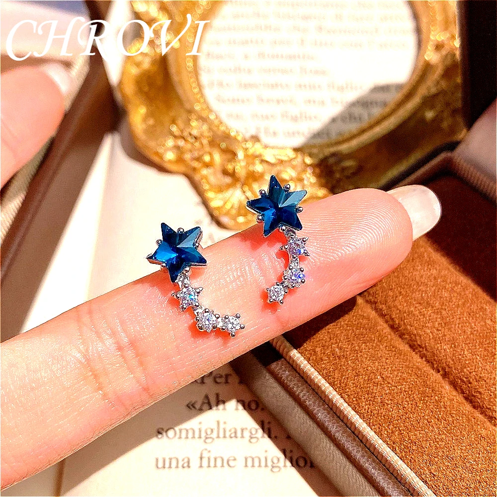 Luxury 925 sterling silver single-row curved zirconia stud earrings for women, with a fresh and light blue crystal star design.