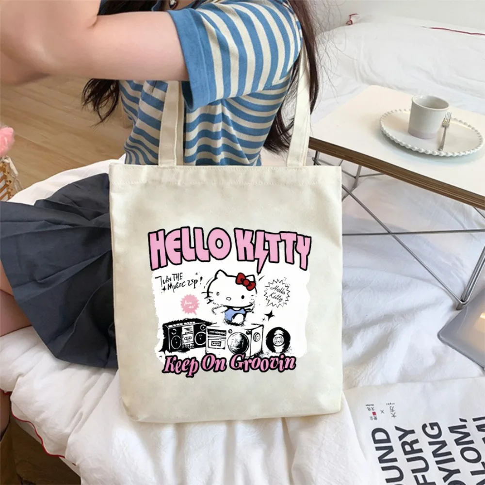 

Cute Hello Kitty canvas tote bag with cartoon design, reusable shoulder bag – an ideal gift for girls or women.