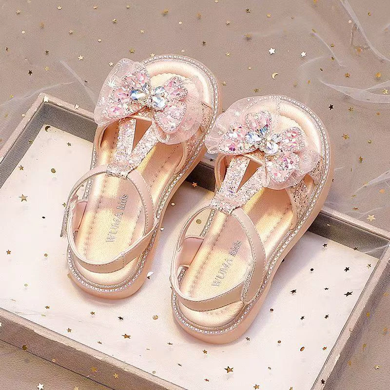 Kleinkind Mädchen T-Riemen Ledersandalen mit Süßer Schleife 2026 Neue Sommer Kinder Kristallsandalen Weiche Sohle Trendige Prinzessinnen-Partyschuhe – Detail 2