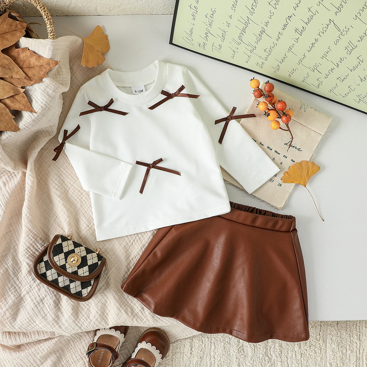 طفل الفتيات الملابس مجموعة ربيع الخريف نمط قصير القوس كم طويل أعلى + تنورة جلدية قصيرة 2 قطعة ل 3-24 متر الفتيات الزي الأنيق
