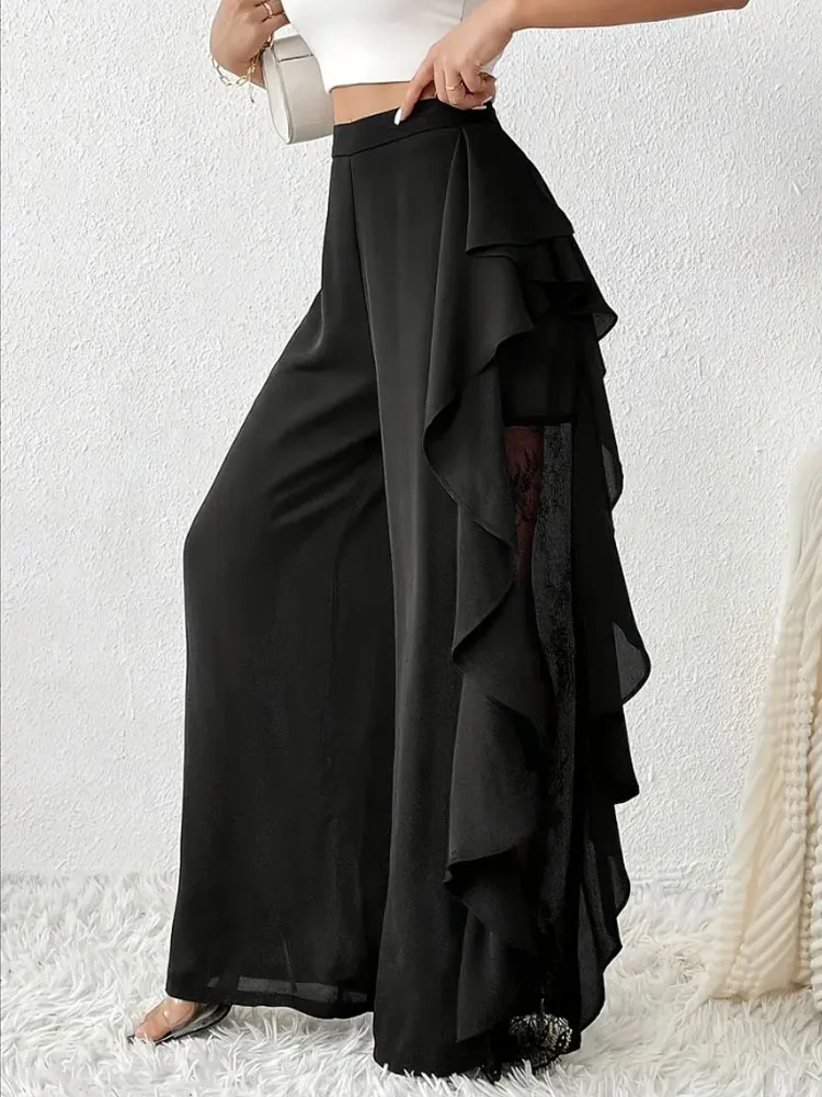 Pantaloni alla moda e cadenti in rete di pizzo irregolare a fessura a vita alta