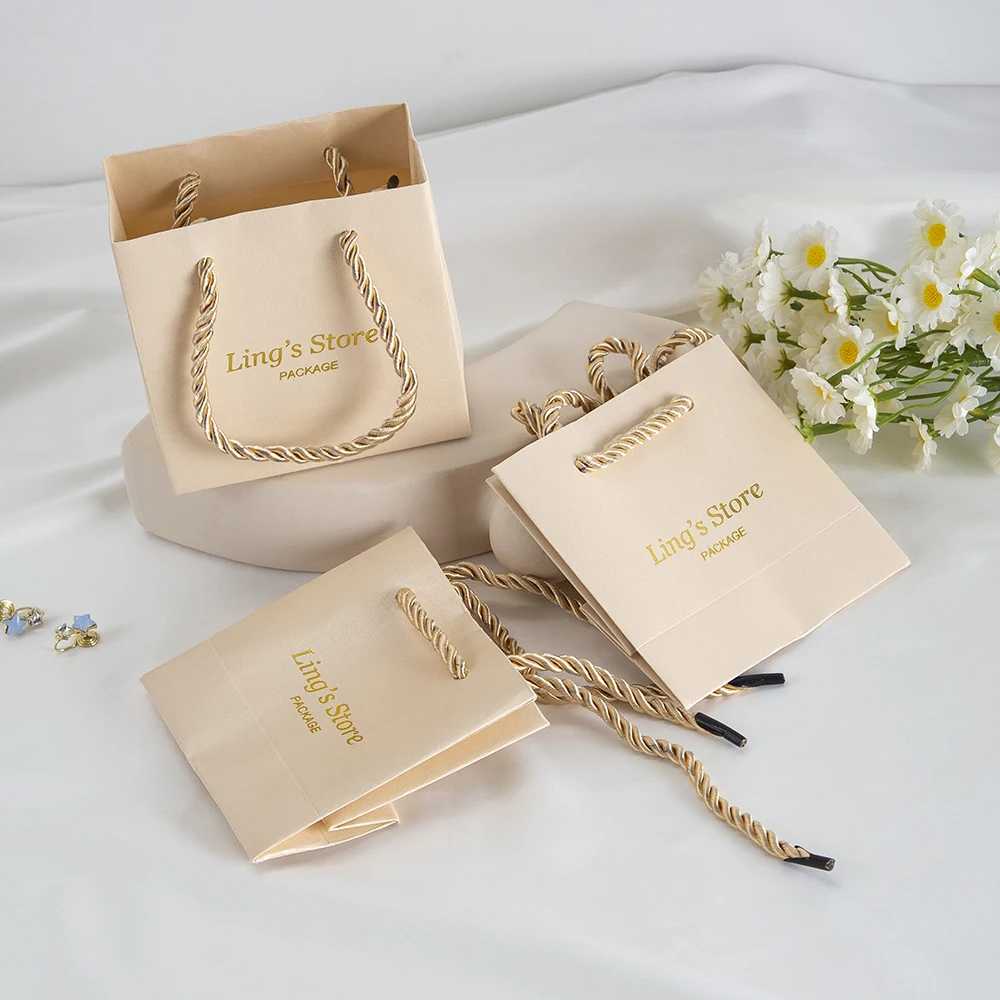 

20/50/100Pcs Custom Logo Beige Jewelry Paper Handle Bag Chic Necklace Pendant Bracelet Wig Makeup Box Storage Case Candy Handbag