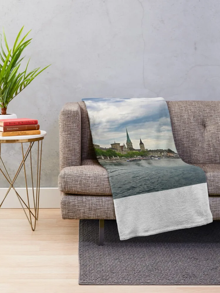 Zurich old town view from the river area with the view of Grossmunster,Fraumunster and St.Peter church clock tower Throw Blanket