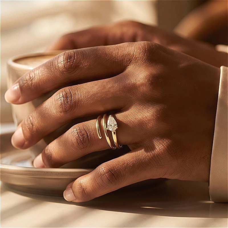 A 1.5-carat teardrop-shaped moissanite three-strand ring in 925 sterling silver, unisex.