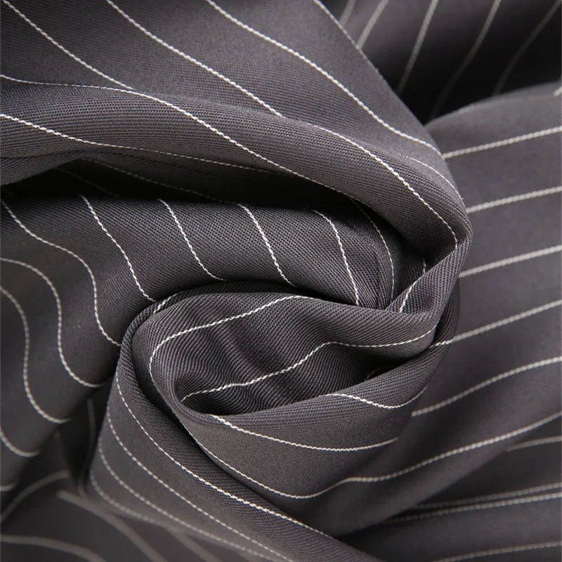 KEANKETIAN PRIMAVERA/otoño nuevo traje de rayas grises de diseño Irregular para mujer prendas de vestir exteriores para oficina con cinturón abrigo ajustado de longitud media