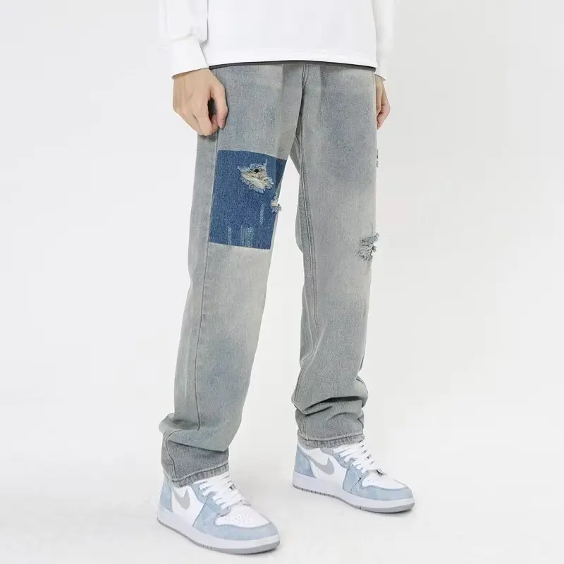 Vintage Distressed zgrywanie jeansy rozkloszowane męskie Streetwear Patchwork Hip-Hop ciężkie pranie niebieski Slim Fit spodnie dżinsowe dla mężczyzn 5058