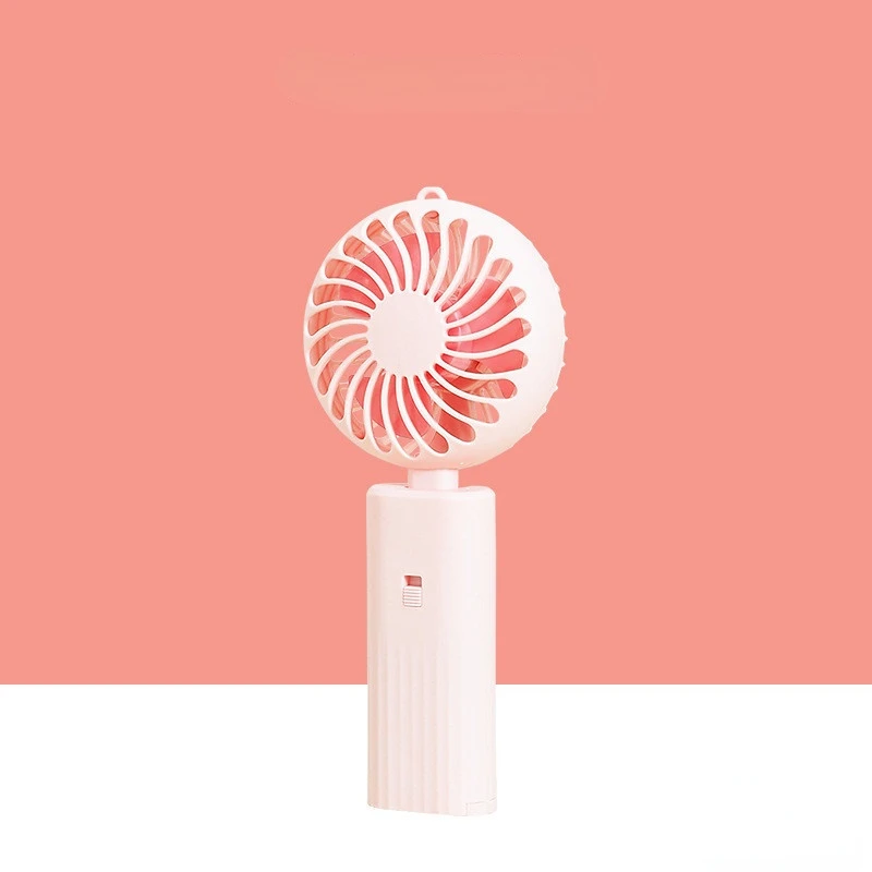 New foldable hand-held small fan Mini portable desktop fan Simple shape, strong wind speed, driven by two AA batteries