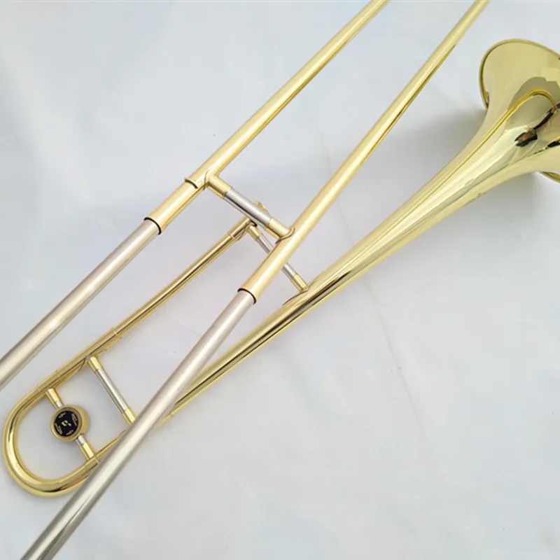 A brass lacquered gold trombone instrument with case in the flat B tone of the baritone