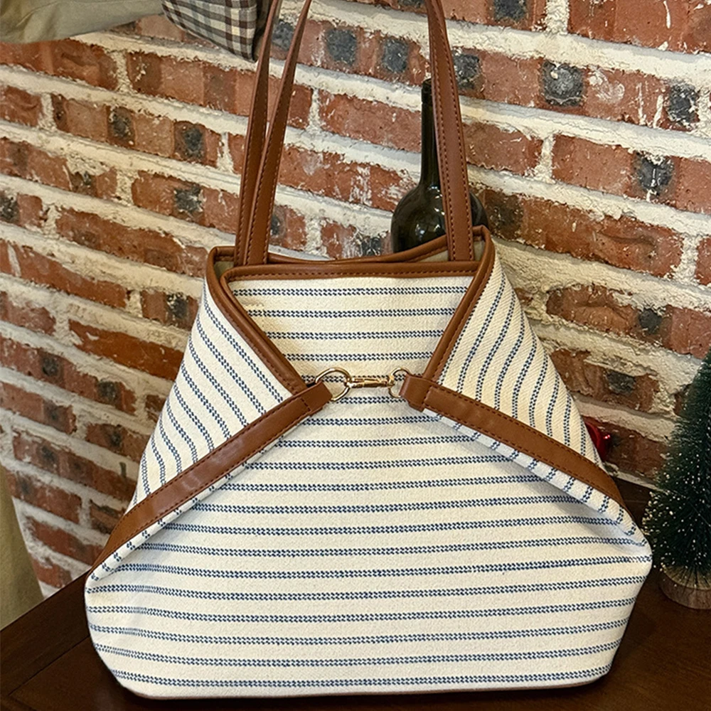 

Large capacity tote bag for women 2025 new high-end commuting single shoulder canvas bag, niche versatile armpit bag