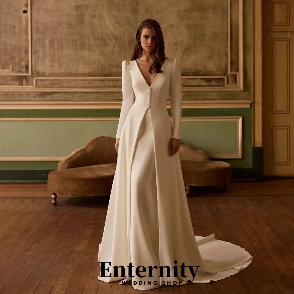 カスタマイズされたバックレスウェディングドレスエレガントなハイネック長袖女性のための魅力的なフリルブライダルガウン Vestidos De Novia