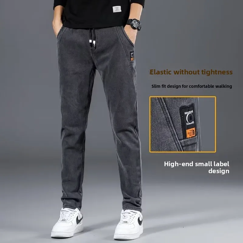 Jeans casual in vita elastica da uomo primavera nuovi pantaloni lunghi larghi a gamba dritta gioventù trendy tessuto denim blu resistente all'usura