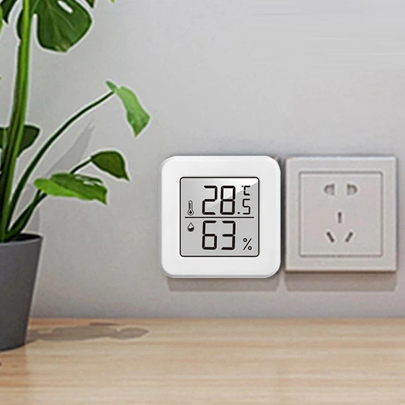 New-1207 มินิอิเล็กทรอนิกส์อุณหภูมิและความชื้นเครื่องวัดอุณหภูมิรถยนต์พร้อมจอแสดงผลหน้ายิ้มเครื่องวัดอุณหภูมิในครัวเรือนในร่ม