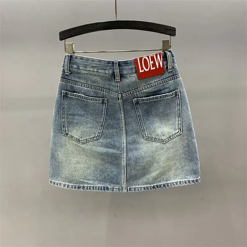 Embroidered hole denim skirt female 2024 summer new high waist fashion temperament slim A word bag hip elegant skirt.