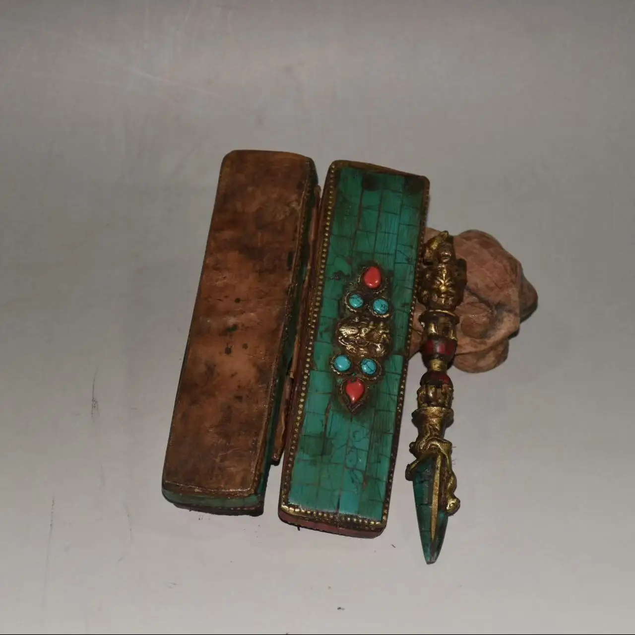 

A box of Nepalese bronze with turquoise and red pine inlaid, containing ritual objects